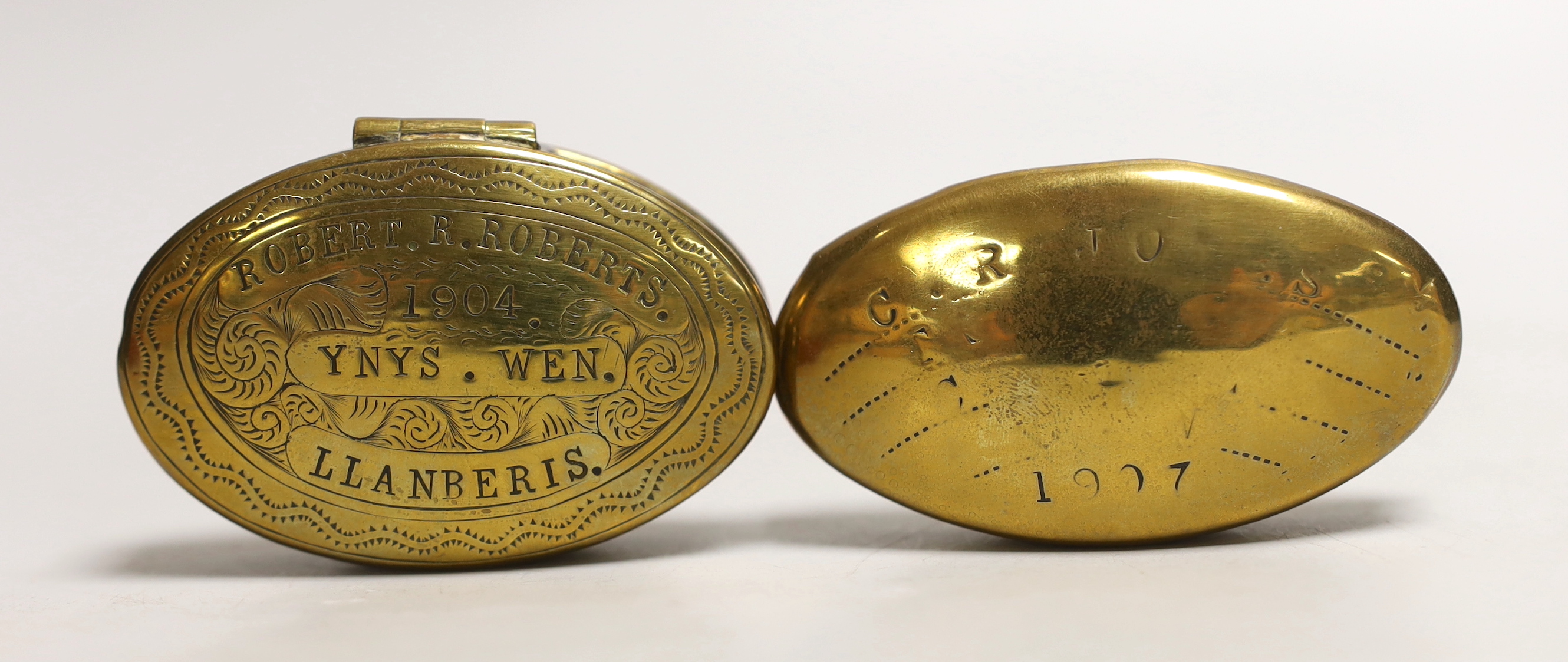 Two early 20th century brass miners’ snuff boxes, one with Welsh inscription